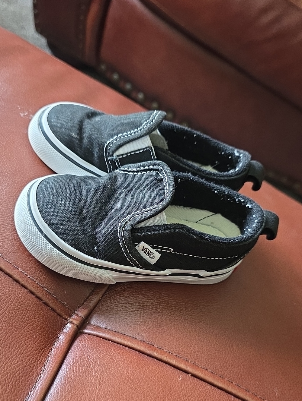Vans Kids Slip-On Canvas Sneakers in Black and White